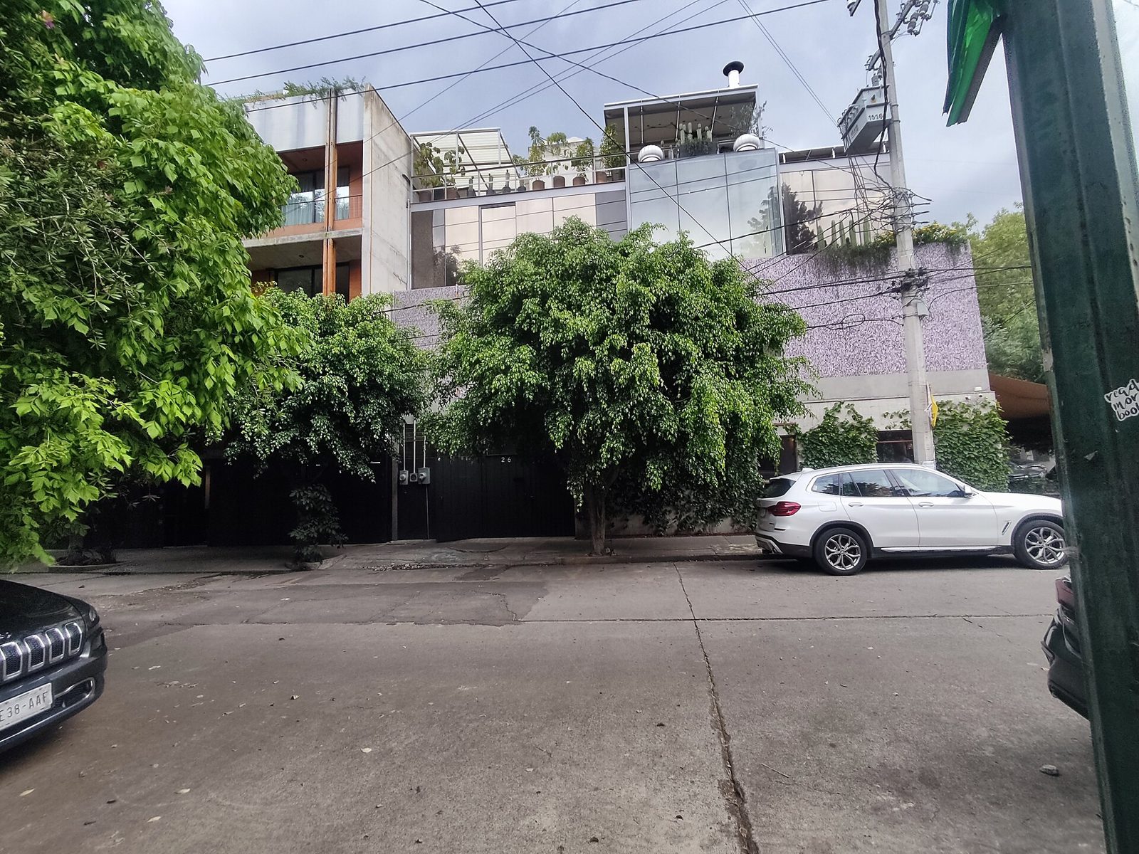 The tree-shaded street front of Baldío