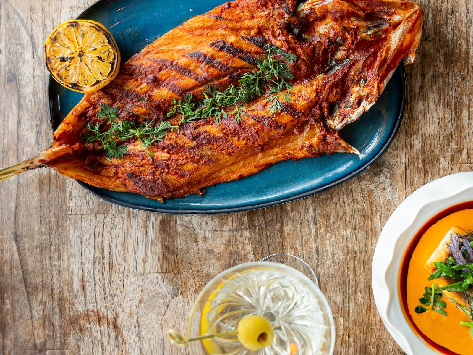 Grilled fish and a martini served at Cabuya Rooftop