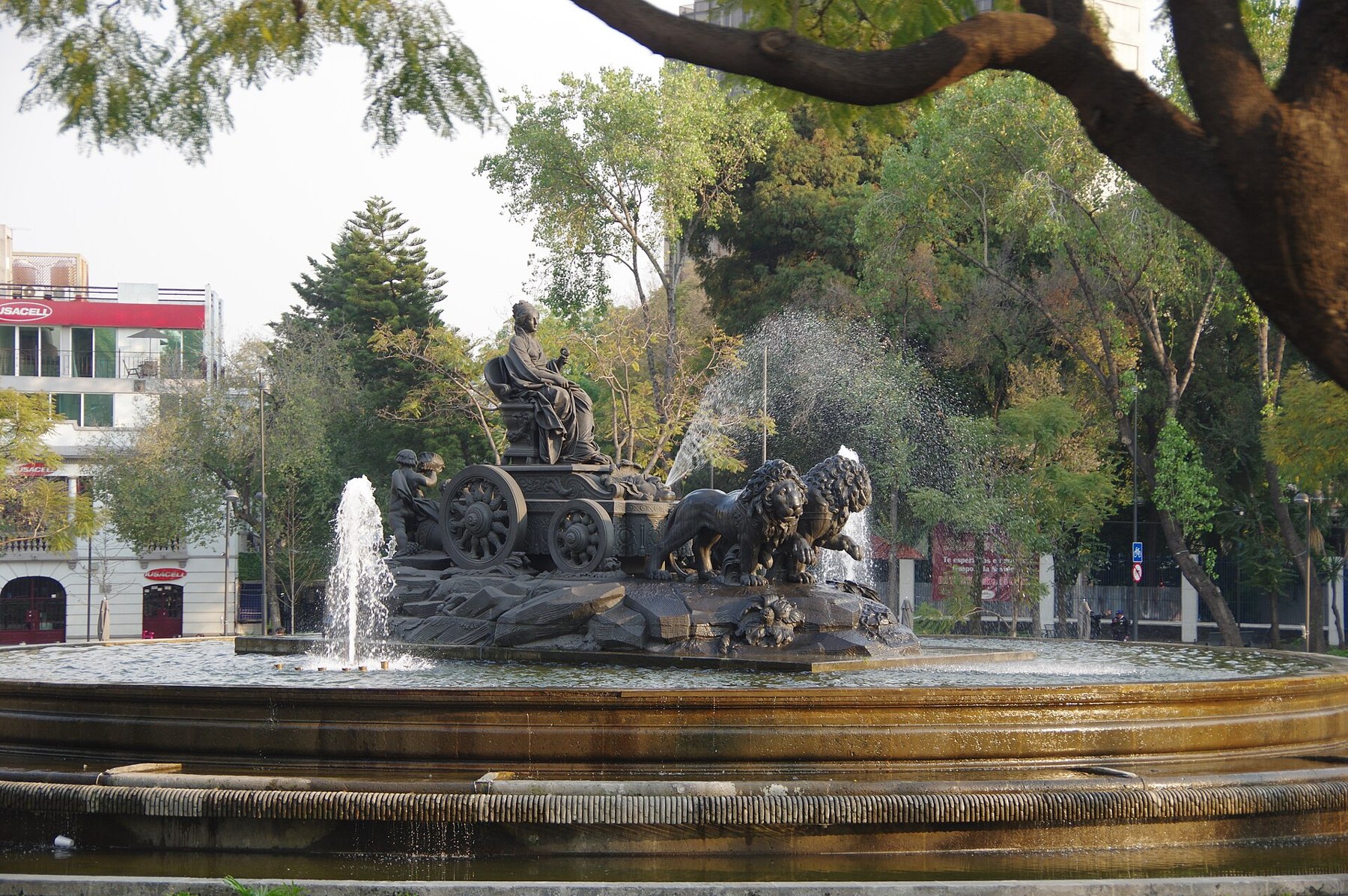 Cybele and the lions of the Cibeles fountain in Plaza Villa de Madrid, Roma Norte
