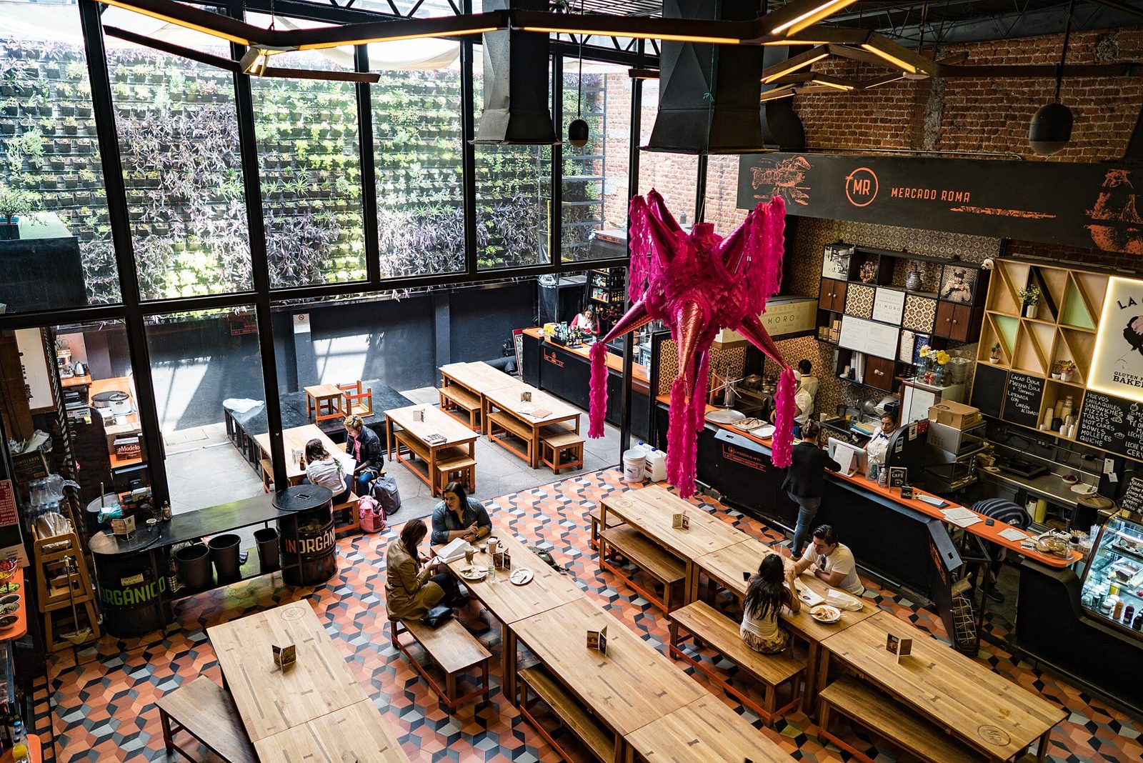 Communal tables and food stalls inside Mercado Roma