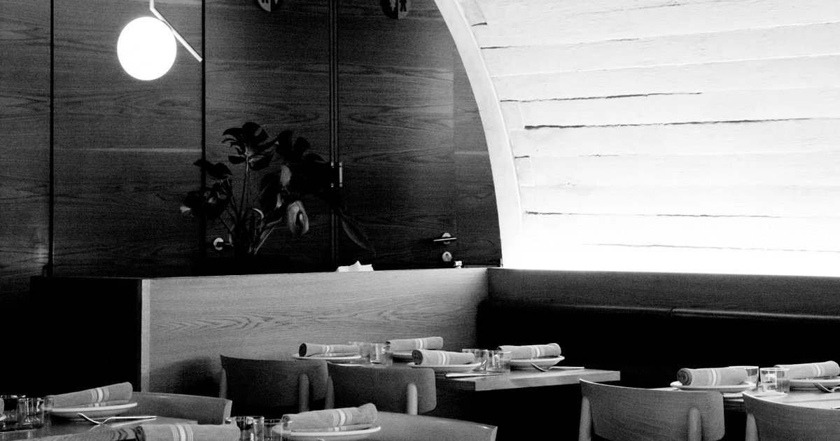 Black-and-white view of Sartoria’s dining room